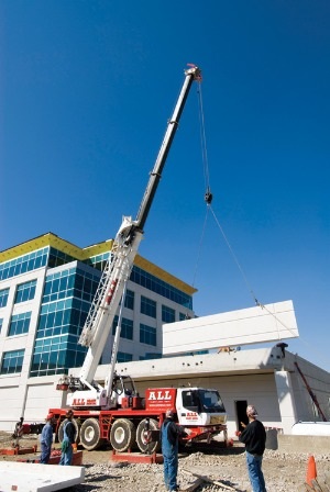 GMK4100B hydraulic truck crane lifting precast sections.