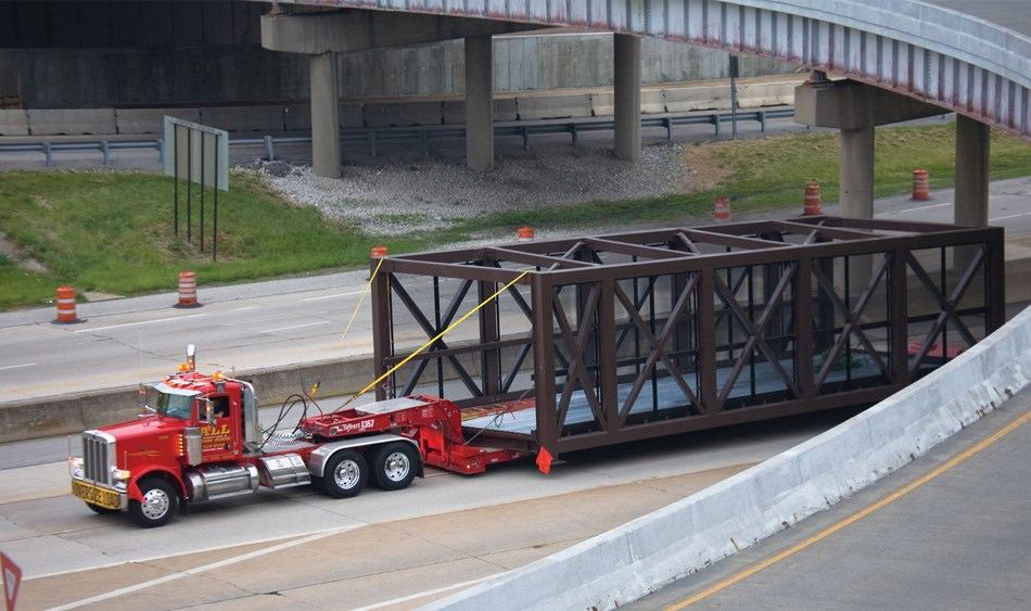 Truck transporting building structure