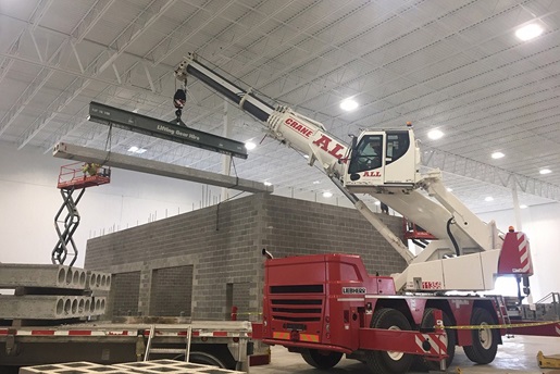 Liebherr LTC 1050-3.1 constructing a small precast building inside another building