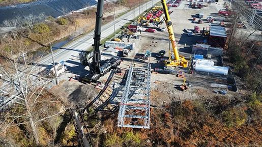 Two large cranes working on a bridge