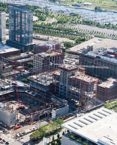 Three big crawlers and a tower crane at McCormick Square in Chicago.