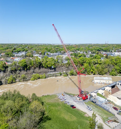 Going to Great Lengths CS 1 red crawler crane working on a dam