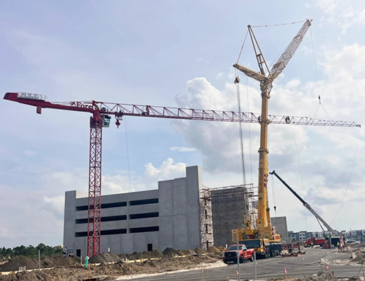 Red tower crane and a yellow all-terrain crane