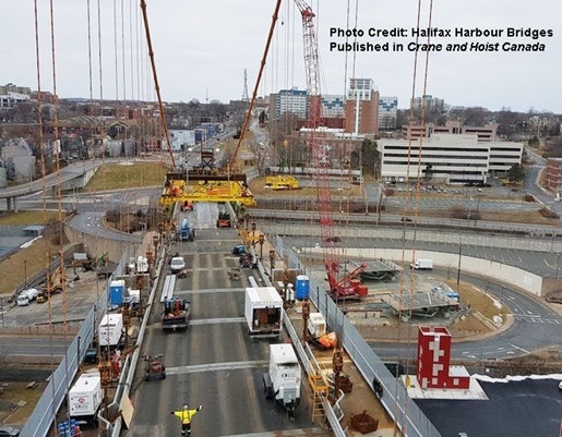 Two big crawler cranes lifting Angus L. Macdonald Bridge