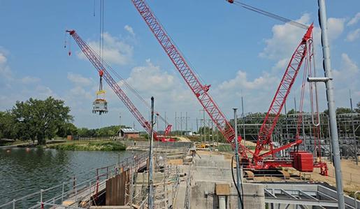 Red Crawler Cranes working by water