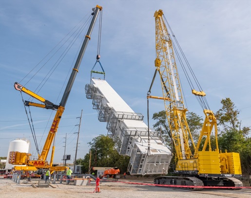 STATE OF MATTER cranes lifting building