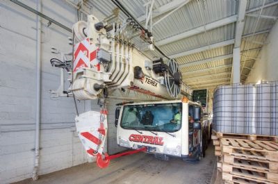 120-ton Terex AC 100/4(L) all-terrain crane driving through a narrow tunnel