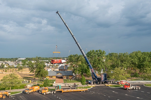 Blue Beast all-terrain crane lifting train caboose