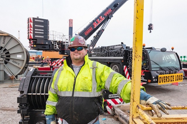 Worker in front of crane
