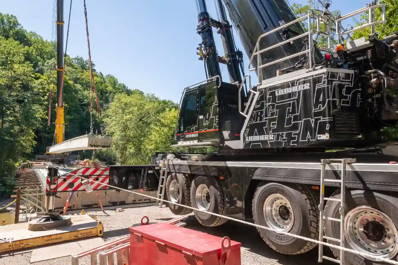 A company using a rented crane on a job site.