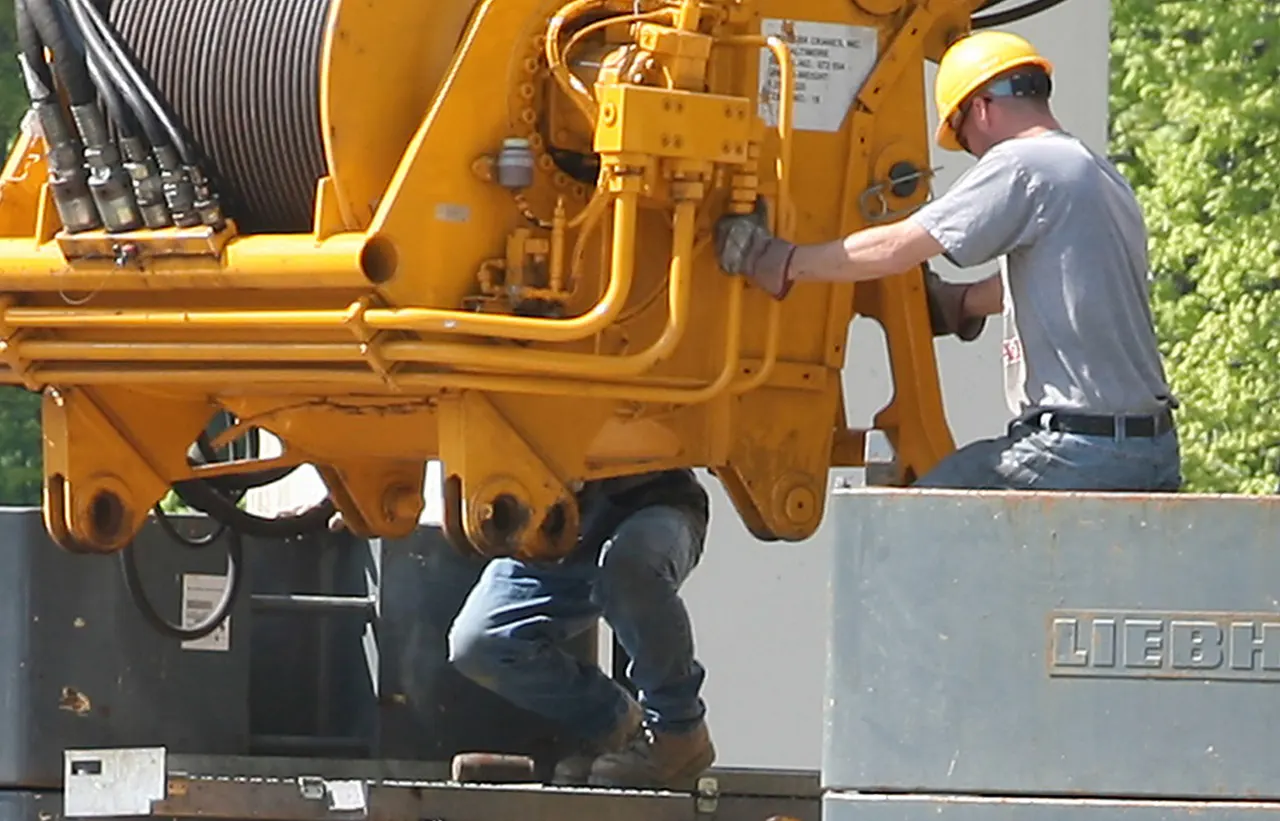 A specialist performing maintenance on a crane.